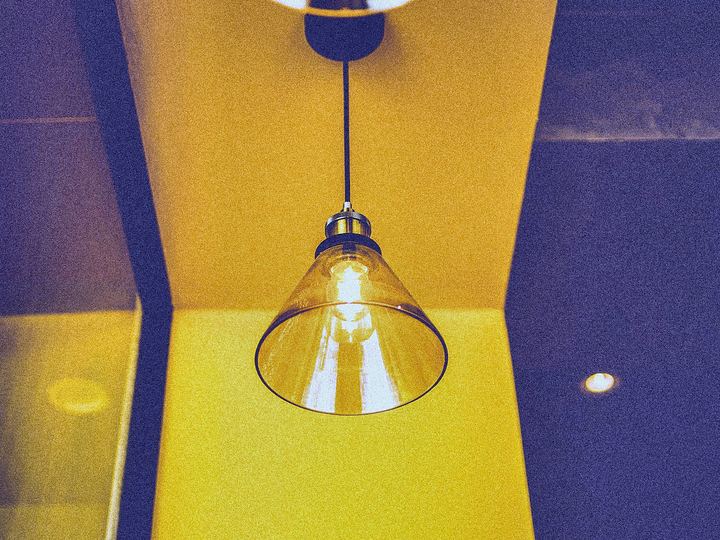 Glass pendant lights glowing in a yellow hallway
