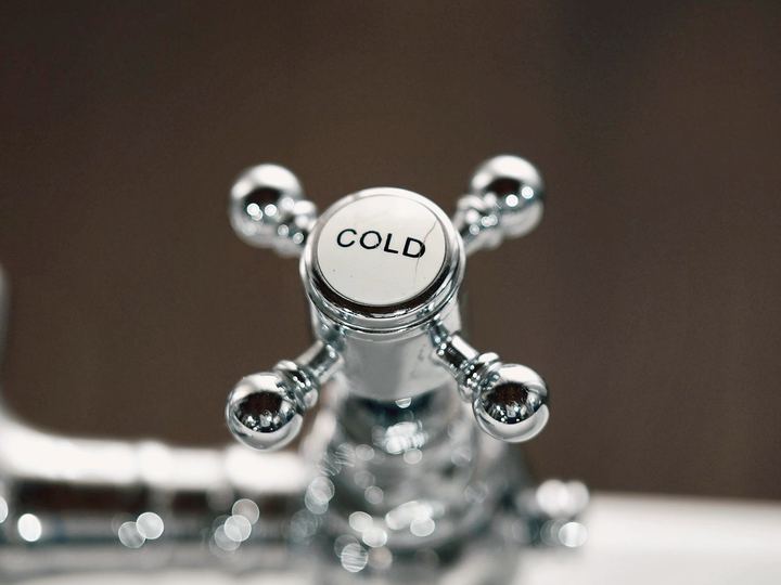 Chrome cross-handle tap on a white basin