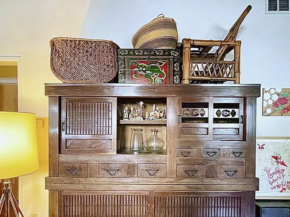 Antique wood cabinet with glass doors after restoration