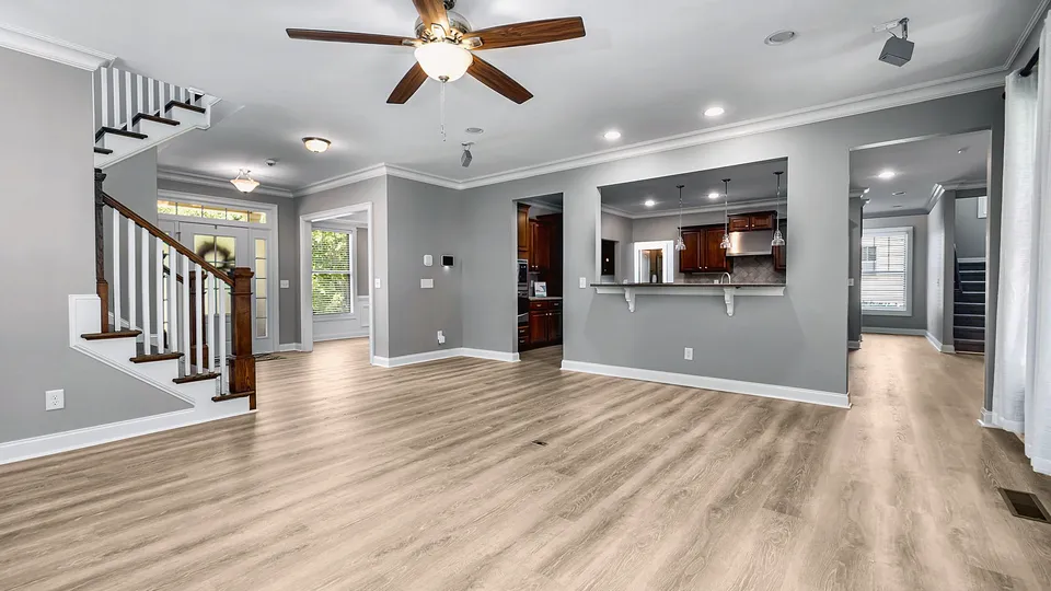 Ceiling fan with wood blades in an open living room