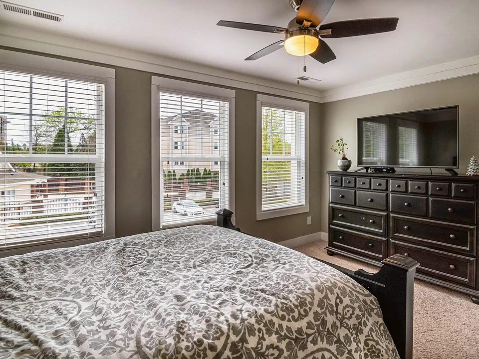 Bedroom with a ceiling fan and light kit