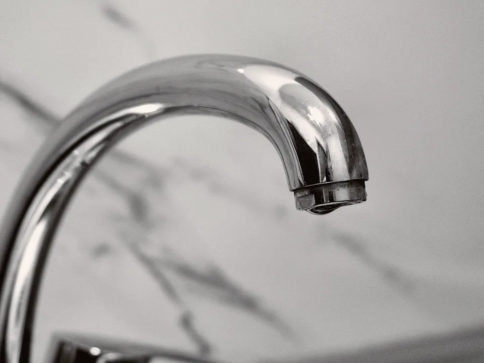 Close-up of a chrome faucet spout