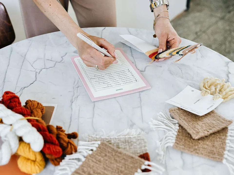 Hand writing a list on a notepad