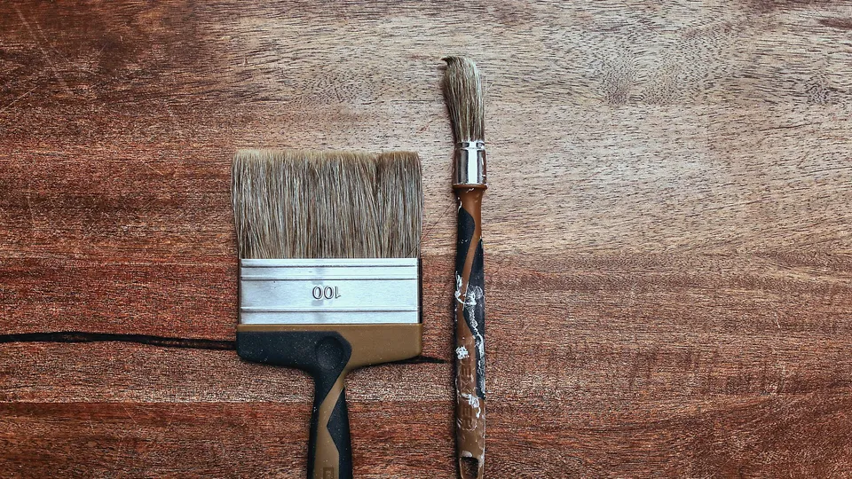 Paintbrush resting on a wood surface