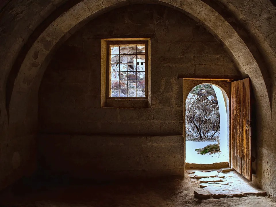 Arched doorway set in a thick plaster wall