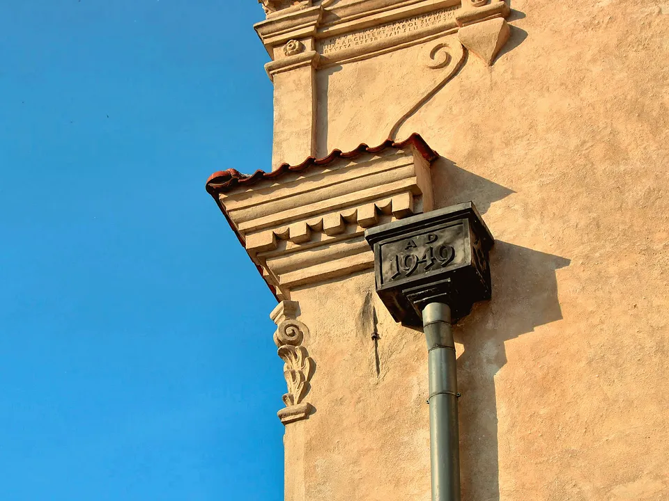 Downspout running down a stucco wall