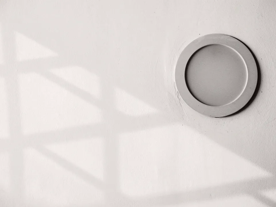 Close-up of a slim round LED light in a white ceiling
