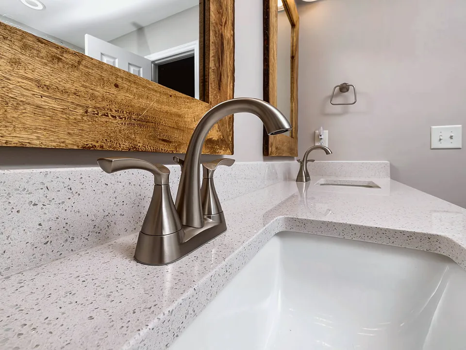 Bronze faucet on a white bathroom sink