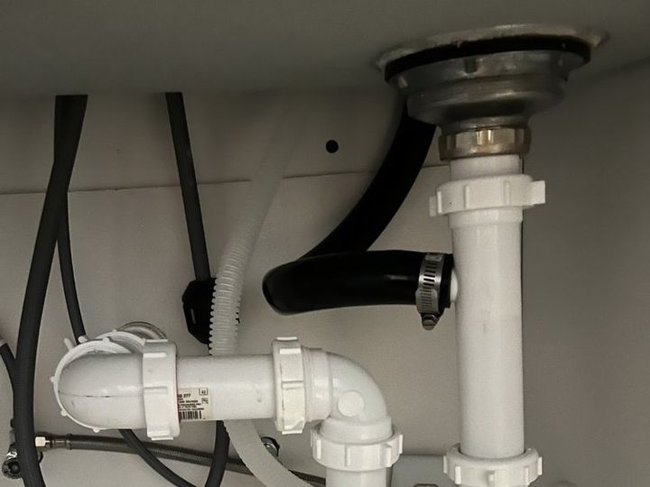 Under-sink drain we rebuilt with new white P-trap and tailpiece fittings