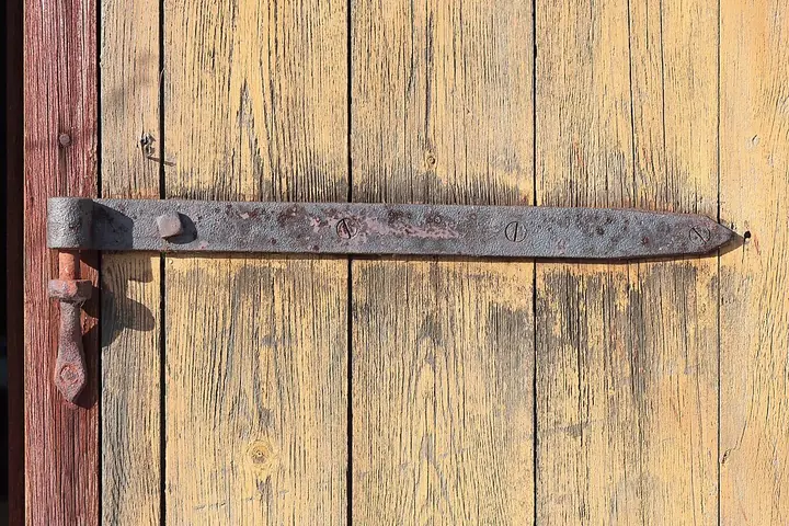 Strap hinge on a wooden door