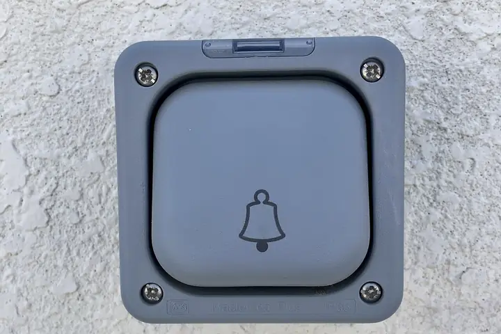 Doorbell button on a wall