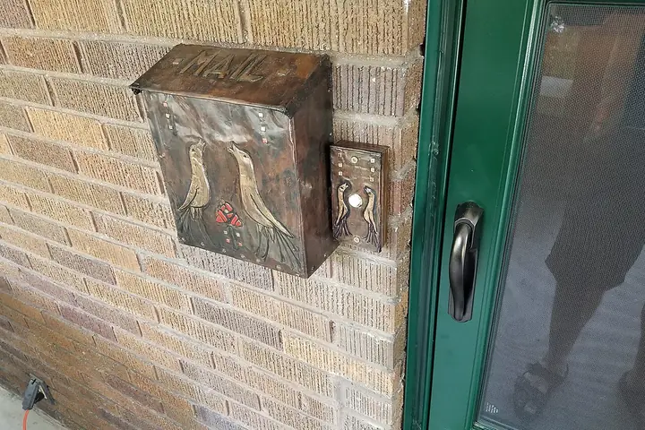 Doorbell box mounted by an entry
