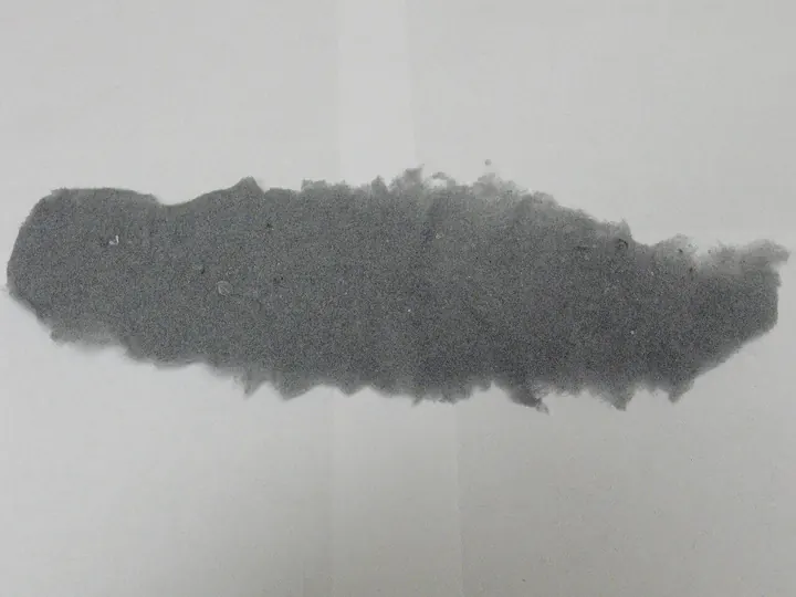 Sheet of gray lint pulled from a dryer screen