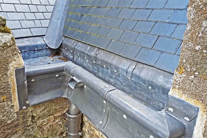 Metal gutter along a roof edge