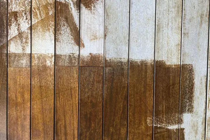 Wood fence boards with peeling white paint