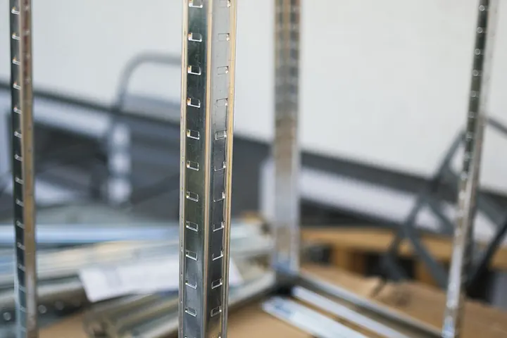 Metal shelving uprights and parts laid out for assembly