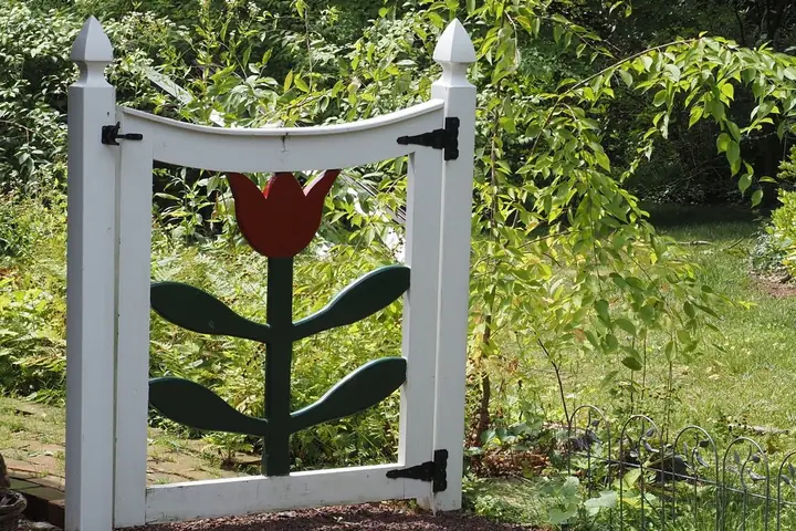 A garden gate with tulip design located in a lush outdoor area of Doylestown, Pennsylvania