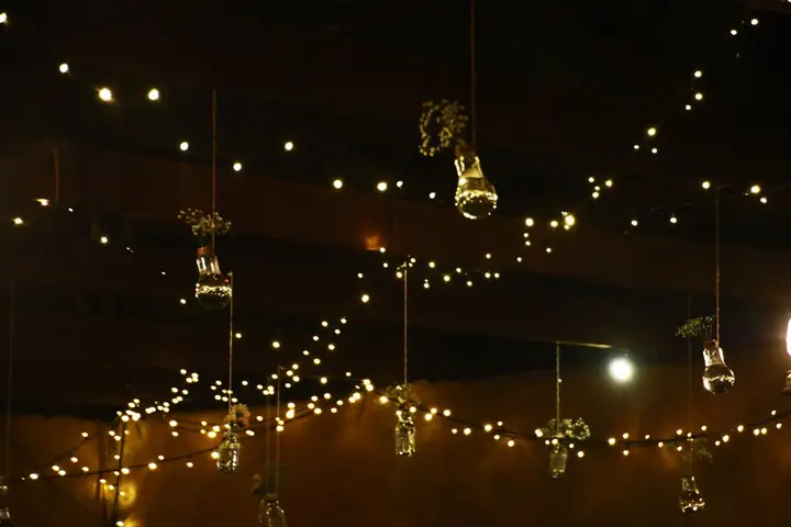 Indoor scene with string lights and hanging jar decor creating a warm ambiance