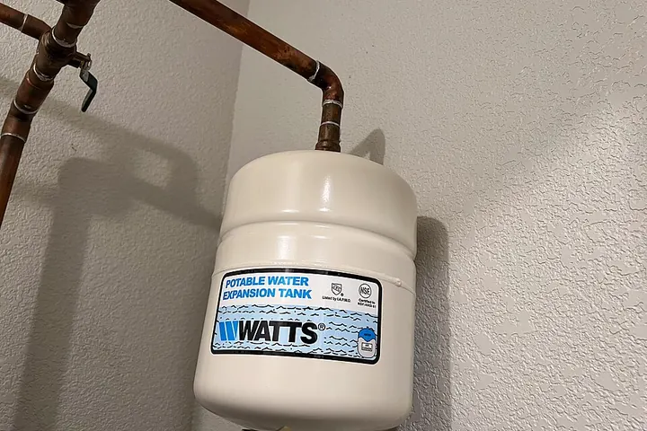 Expansion tank mounted near a water heater