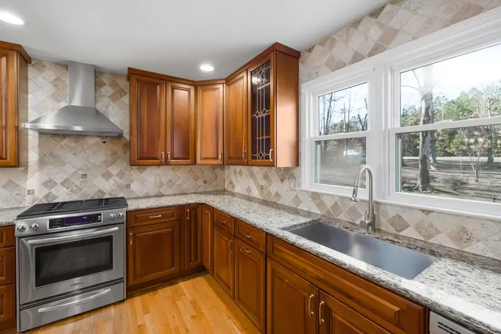 Kitchen with granite countertops and natural light from large windows