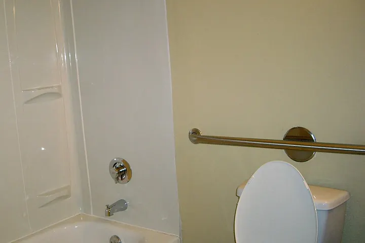 Grab bar mounted beside a toilet