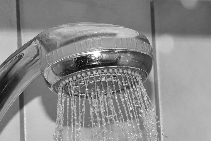 Water spraying from a chrome shower head