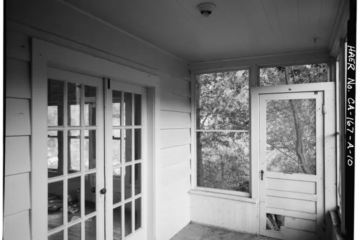Screened porch with a glass-paneled screen door beside French doors